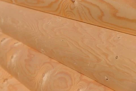 Stack of round timber logs for building wooden house. Removing bark from logs Stockfoto's