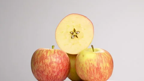 Stack Of Royal Gala Apples With Half Cut On Top Rotating White Background 4K Stock Footage 321867112