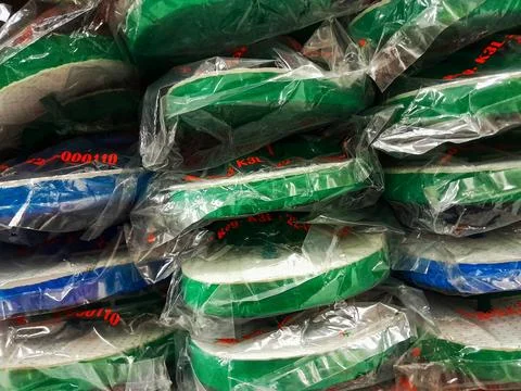 Stack of rubber flip-flops on the supermarket shelves. Stock Photos