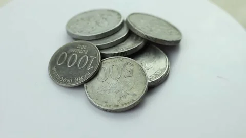 Stack of rupiah coins on a rotating display stand Stock Footage 274668192