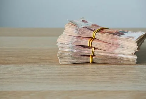 Stack of Russian banknotes on wooden table with space for copying. Stock Photos