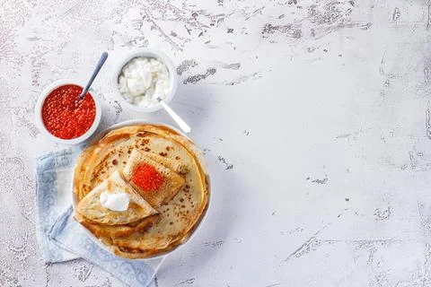 Stack of russian pancakes blini with red caviar, fresh sour cream Stock-Fotos