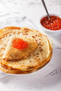 Stack of russian pancakes blini with red caviar, fresh sour cream Stock Photos