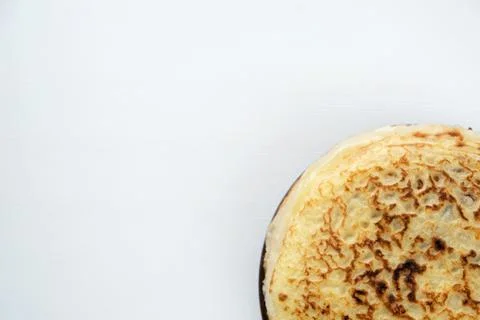 A stack of Russian pancakes on a light rustic wooden background. Stock Photos