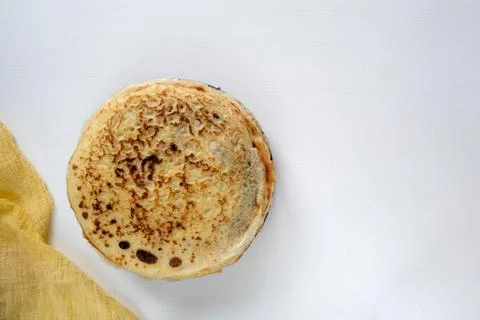 A stack of Russian pancakes on a light rustic wooden background. Stock Photos