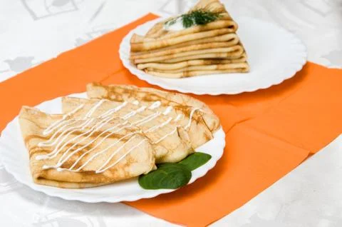 A stack of russian pancakes on a white plate Stock Photos