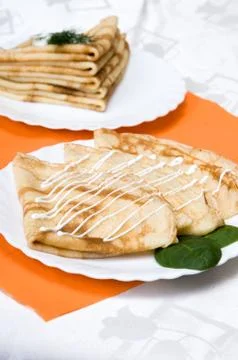 A stack of russian pancakes on a white plate Stock Photos