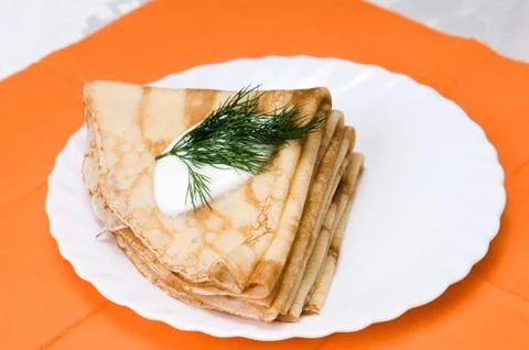A stack of russian pancakes on a white plate Stock Photos