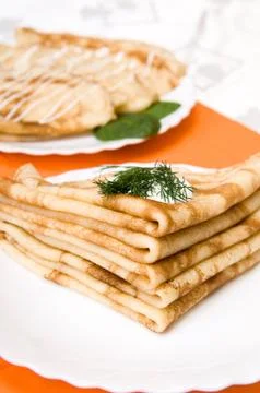 A stack of russian pancakes on a white plate Stock Photos