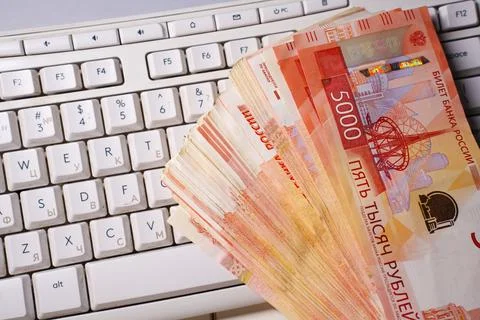 Stack of Russian rubles on computer keyboard, online payment concept Photos