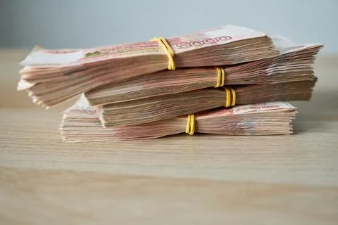 Stack of Russian rubles on a wooden table, close-up Stock Photos