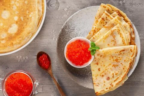 Stack of russian thin pancakes blini with red caviar Stock Photos