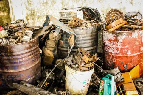 Stack of rusted metallic car machine old parts in garage Stock Photos