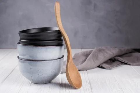 Stack of rustic style handcraft bowls in neutral tones  with wooden spoon. 스톡 사진