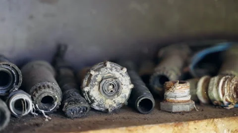 Stack of rusty cut pipes, tubes, hoses, valves and other working tools on shelf Stock Footage 316687890