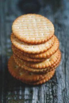 Stack of a of salted crackers on an old wooden table. Stock Photos