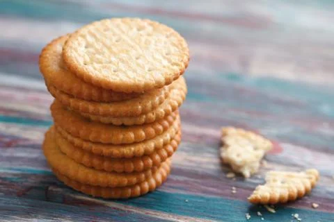 Stack of a of salted crackers on an old wooden table. Stock Photos