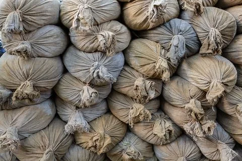 Stack of sandbags protective wall in bad weather, flood background Stock Photos