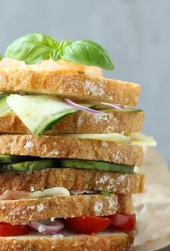 Stack of sandwiches with different fillings on the table 스톡 사진