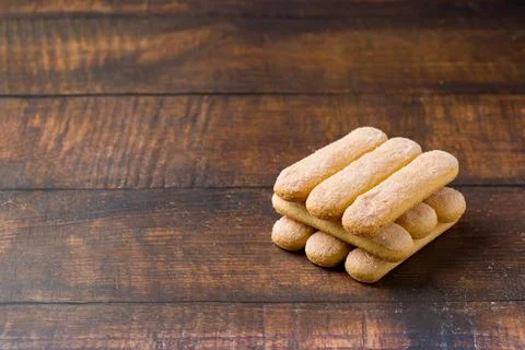 Stack of Savoiardi ladyfinger biscuits on rustic wooden table Stock Photos