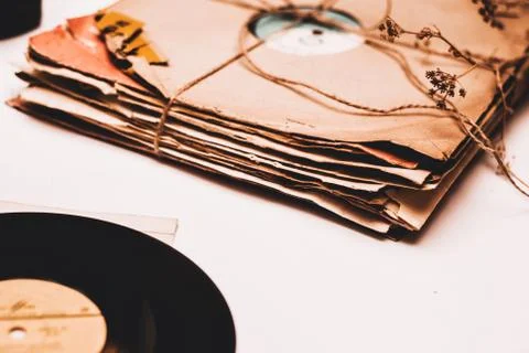 Stack of scratched dusty old vinyl records tied with rope Stock Photos