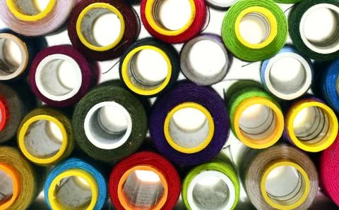 Stack of sewing threads in multicolor background in close up Stock Photos