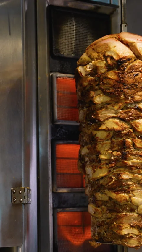 Stack of Shawarma Meat Grilling on Rotisserie Stock Footage 311485033