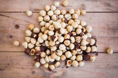 Stack of shelled hazelnuts on wooden background Stock Photos
