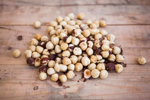 Stack of shelled hazelnuts on wooden background Foto stock
