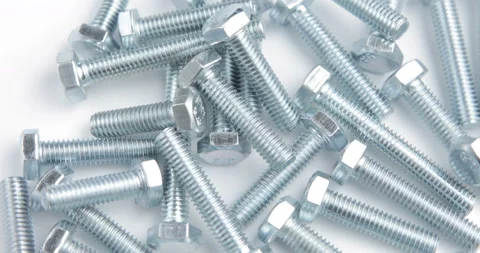 Stack of shiny screw, bolt or stud rotating on a white background Stock Footage 97920989