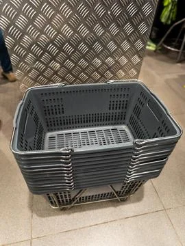 Stack of shopping baskets standing in the store Stock Photos