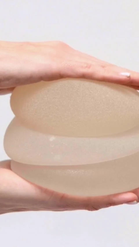 Stack of silicone breast implants being held in a medical clinic, aesthetic medi Stock Footage 342614945