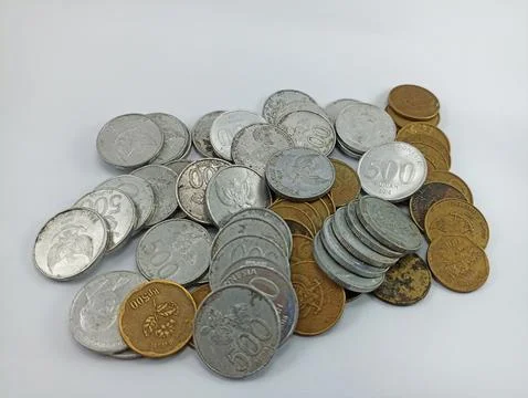 A stack of silver and gold coins on a white background Stock Photos