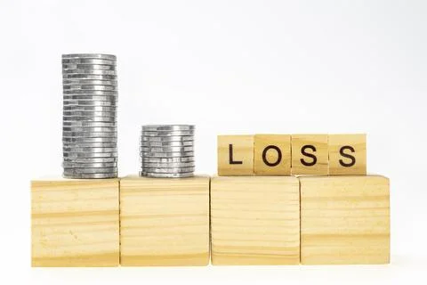 Stack of silver coin with wooden cube with loss words Stock Photos
