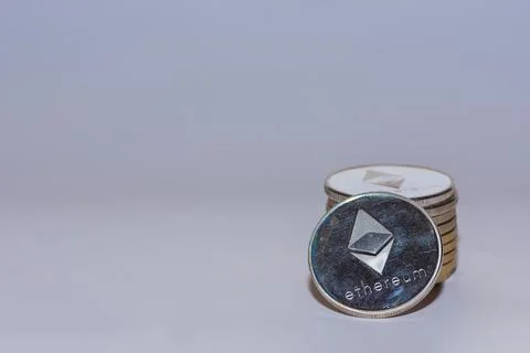 Stack of silver valueable ether coins from crypto currency with gray Stock Photos