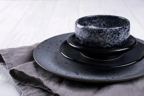 Stack of simple porcelain handmade gray and black plates and  bowls Stock Photos