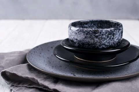 Stack of simple porcelain handmade gray and black plates and  bowls Foto stock