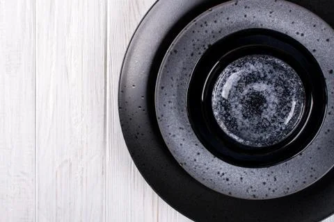 Stack of simple porcelain handmade gray and black plates and  bowls Stock Photos
