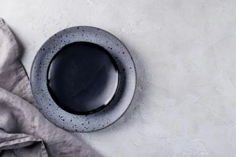 Stack of simple porcelain handmade gray and black plates and  bowls Stock Photos