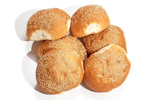 Stack of Six Golden Bread Rolls Sprinkled with Sesame Seeds Stock Photos