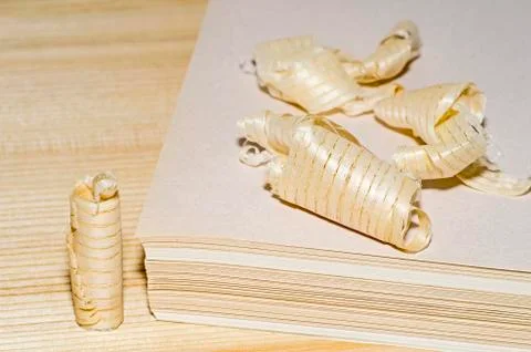 The stack sizing of paper with a symbol shaped chips of wood. The concept of  Stock Photos