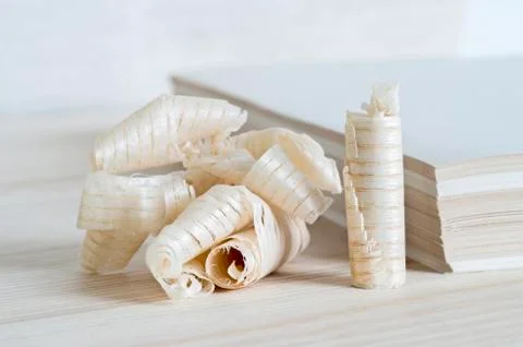 The stack sizing of paper with a symbol shaped chips of wood. The concept of  Stock Photos