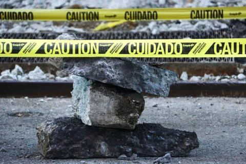 A stack of slabs of pavement with caution sign Stock Photos