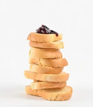 Stack of sliced bread with jam on top on a white background Stock Photos