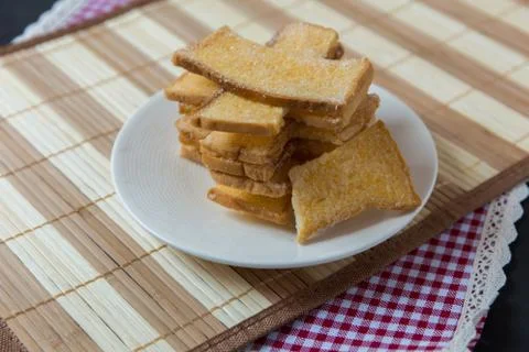 Stack of sliced crispy buttered bread with sugar Stock Photos