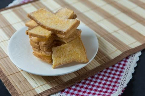 Stack of sliced crispy buttered bread with sugar Stock Photos