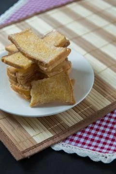 Stack of sliced crispy buttered bread with sugar Stock Photos