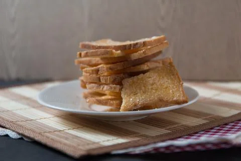 Stack of sliced crispy buttered bread with sugar Stock Photos