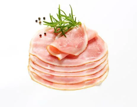 Stack of sliced ham with rosemary garnish Stock Photos