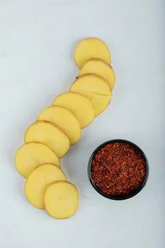 Stack of sliced potatoes and red hot chili pepper 스톡 사진